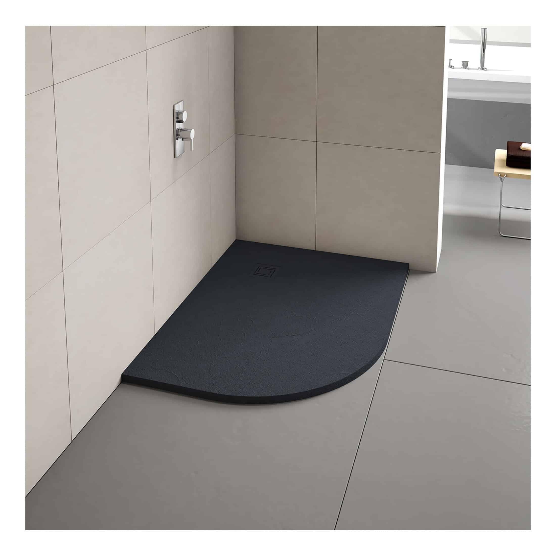 Modern black walk-in shower tray with a gentle curved edge, embedded in a contemporary beige tiled bathroom for luxury showering experience.