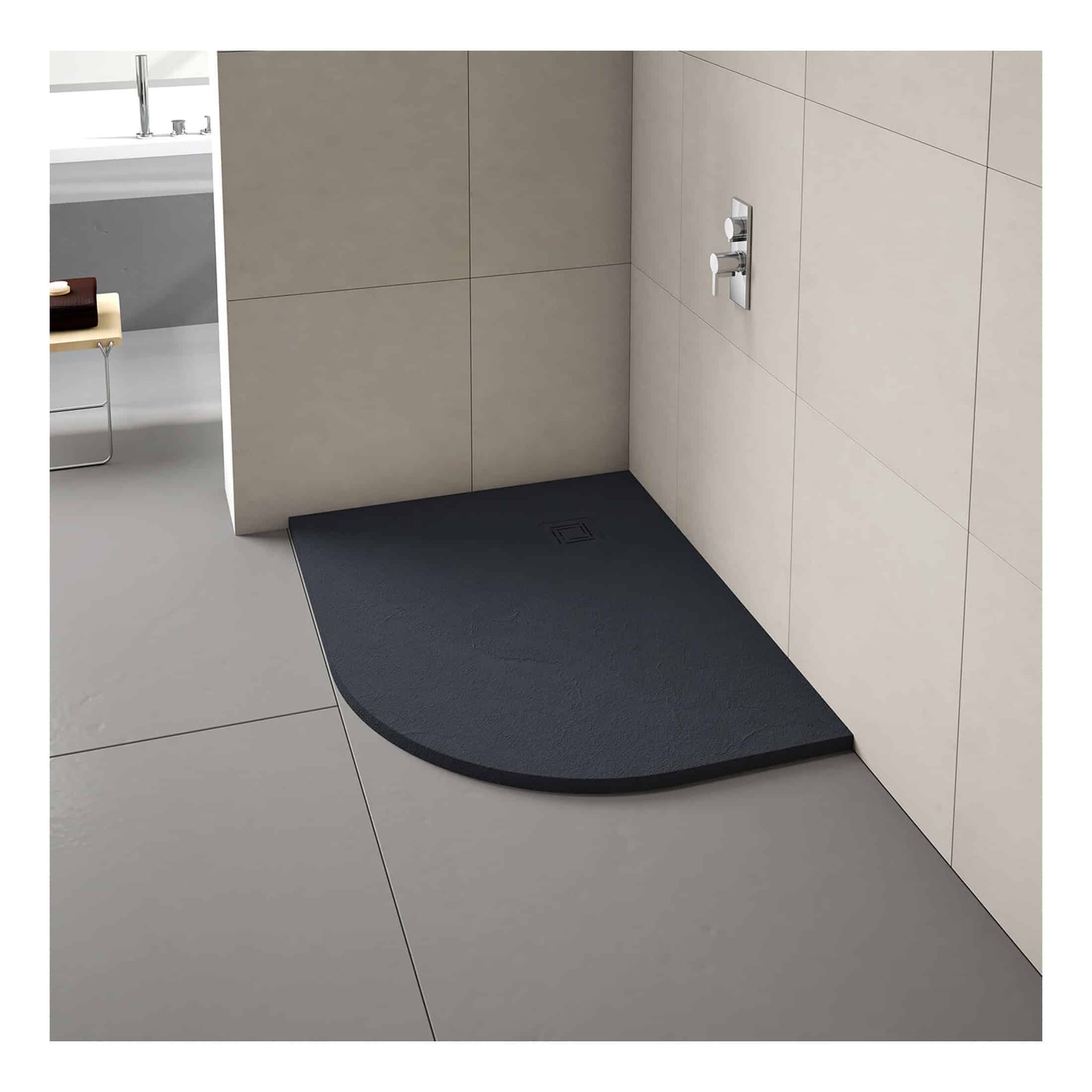Modern black shower tray with curved edge, designed for stylish bathroom shower areas, featuring a central drain and minimalist wall-mounted controls.