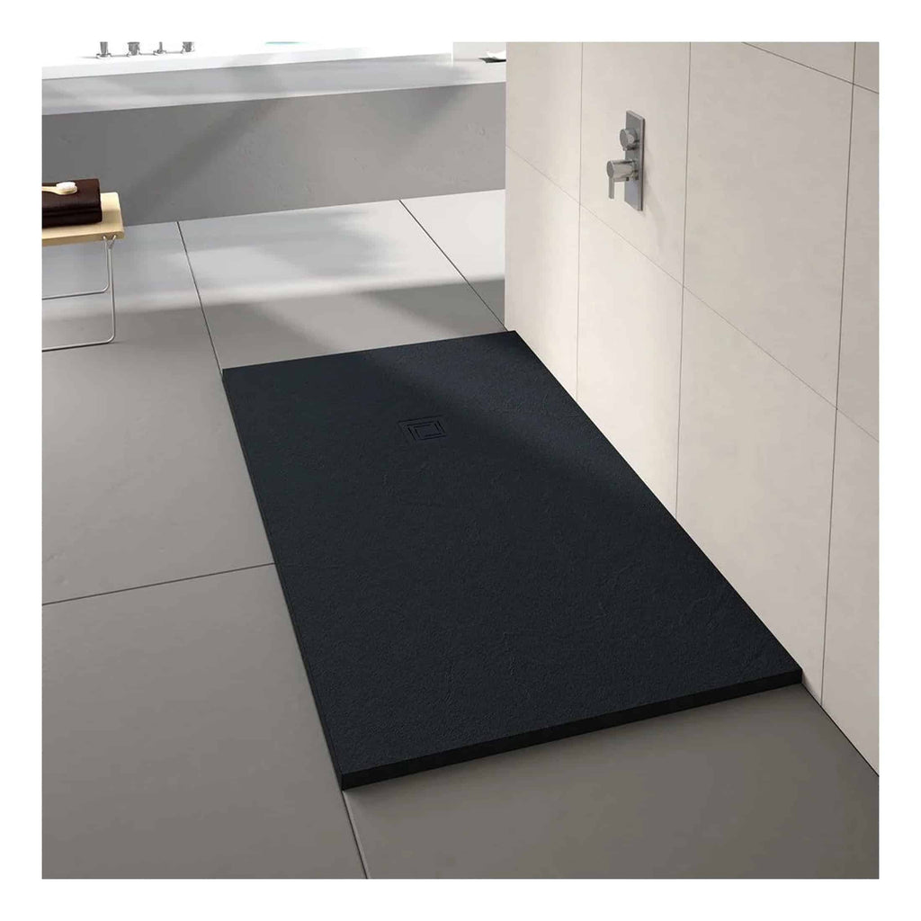 Black shower tray with textured surface and square drain in modern bathroom setting.