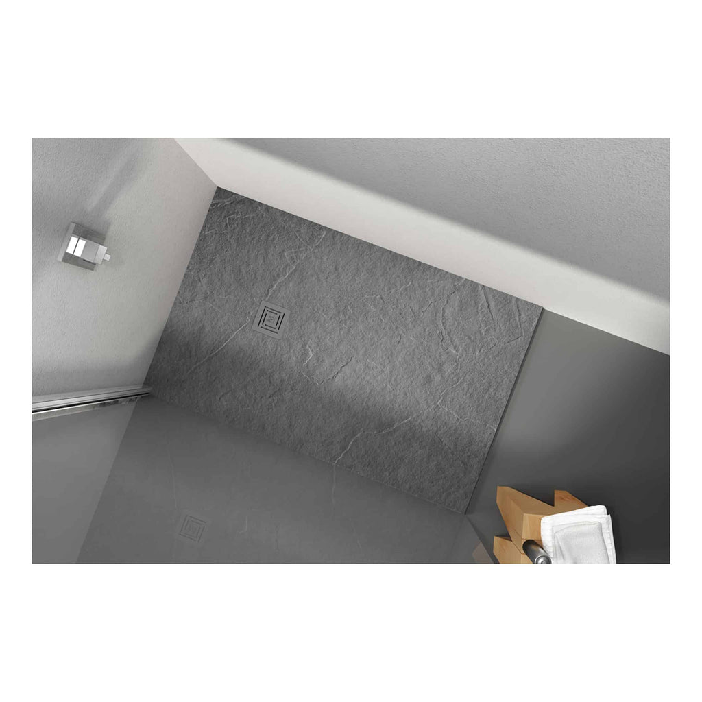 Modern grey walk-in shower with textured stone tiles, chrome drain cover, and minimalist wall fixtures in contemporary bathroom design. Perfect for sleek, stylish bathroom updates.