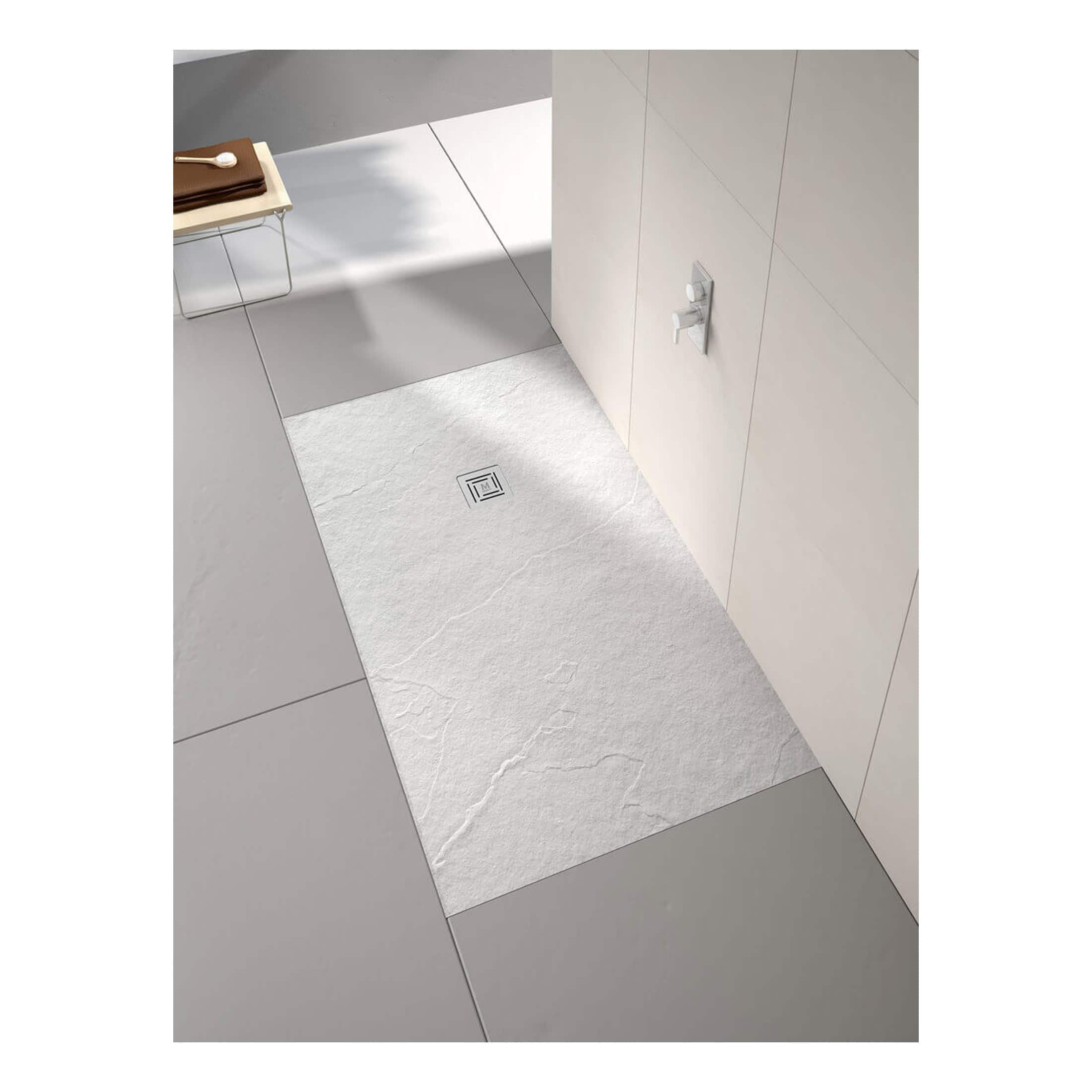 Modern walk-in shower with sleek white textured tile flooring and integrated drainage system, perfect for contemporary bathrooms. Includes minimalist fixtures and clean design for a stylish, functional shower space.