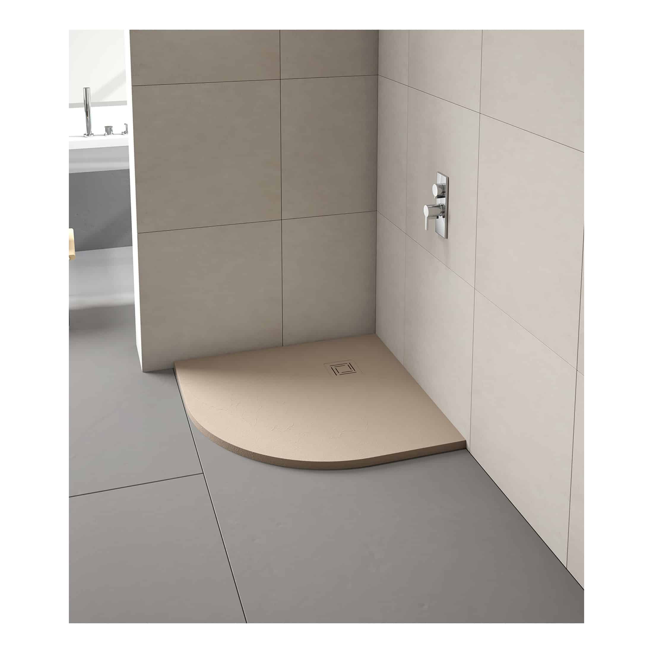 Luxurious walk-in shower with beige textured shower tray, modern wall-mounted controls, and seamless tiling for a sleek bathroom design.