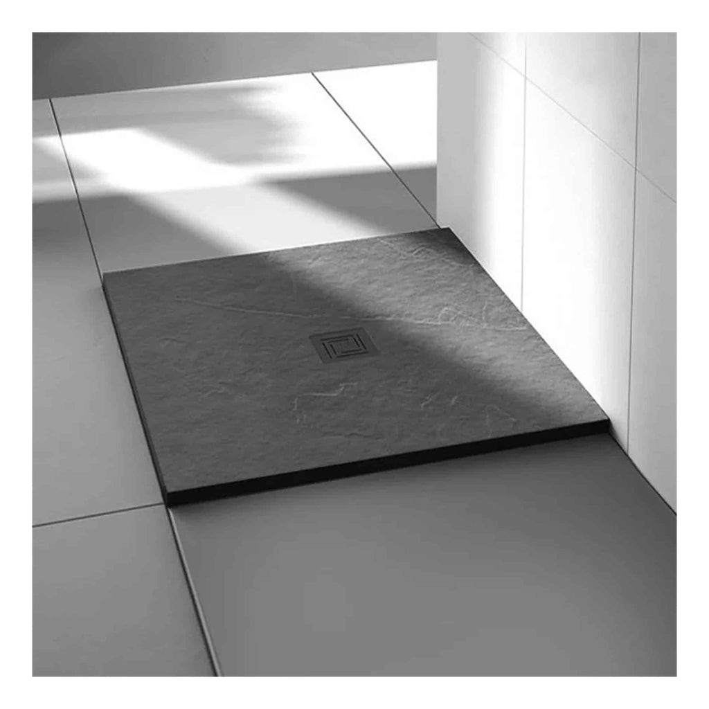 Minimalist bathroom shower drain with a square black edged cover on a tiled floor, modern style, sleek and functional design for contemporary bathrooms.
