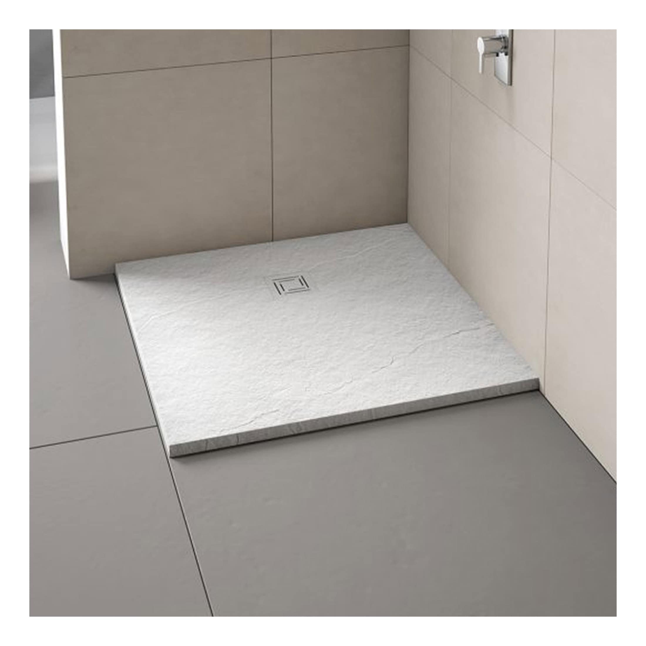 Modern white shower tray with textured surface and centred drain in minimalist bathroom setting.