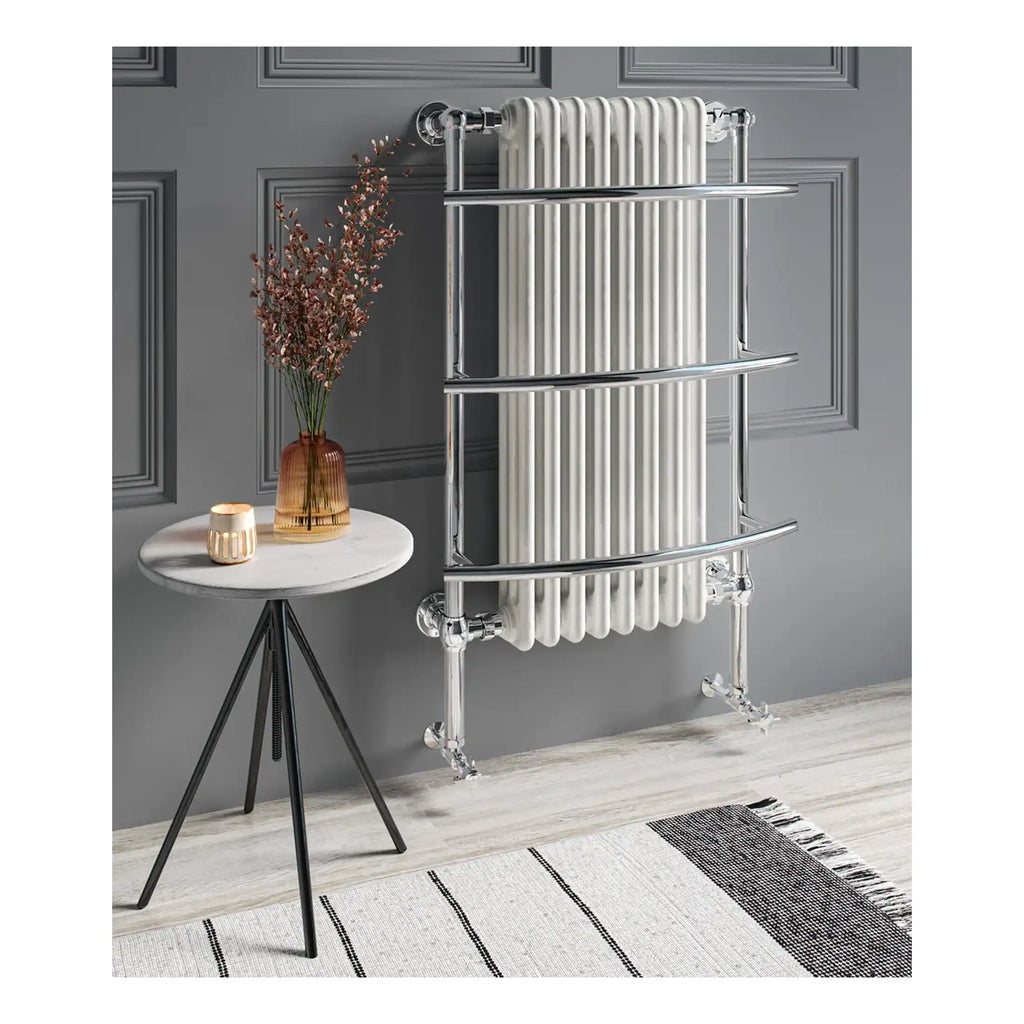 Elegant chrome towel radiator with curved bars, modern bathroom radiator design, perfect for contemporary bathroom decor, by Bubly Bathrooms.