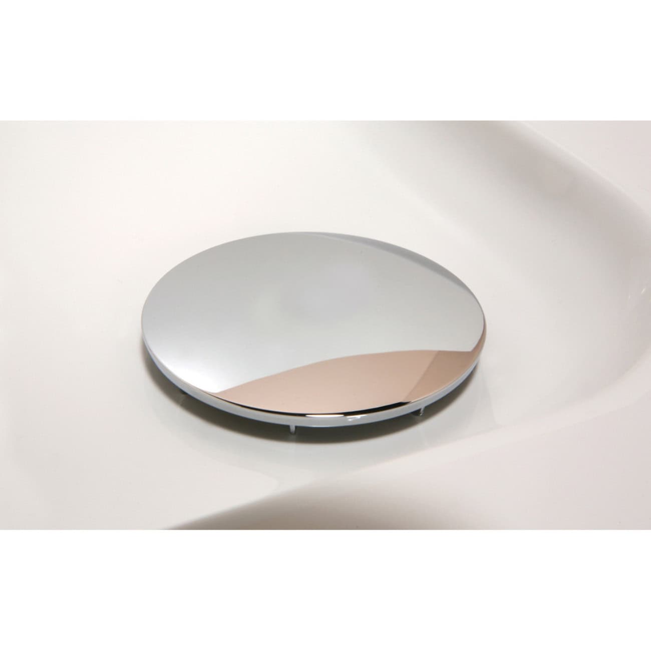 Polished round bathroom mirror with sleek modern design on white countertop for contemporary bathroom decor.