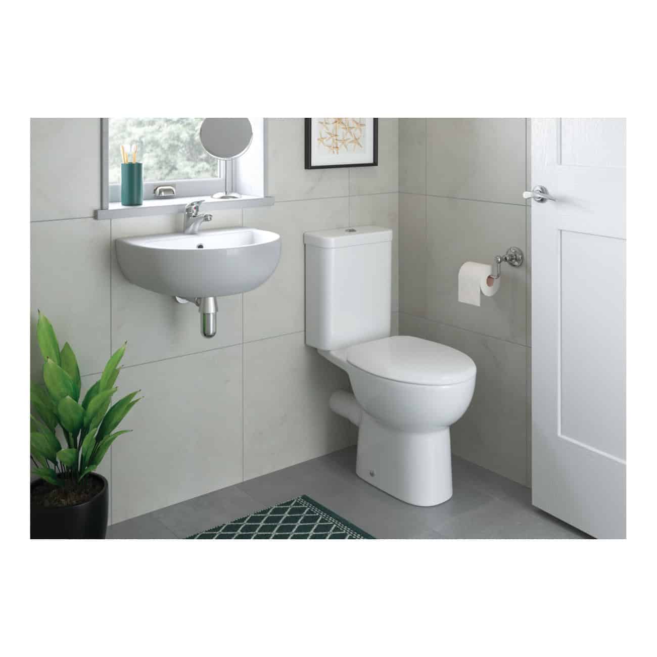 Sleek modern bathroom with white toilet, wall-mounted sink, and minimal decor, featuring neutral tones and practical fixtures for contemporary bathroom design.