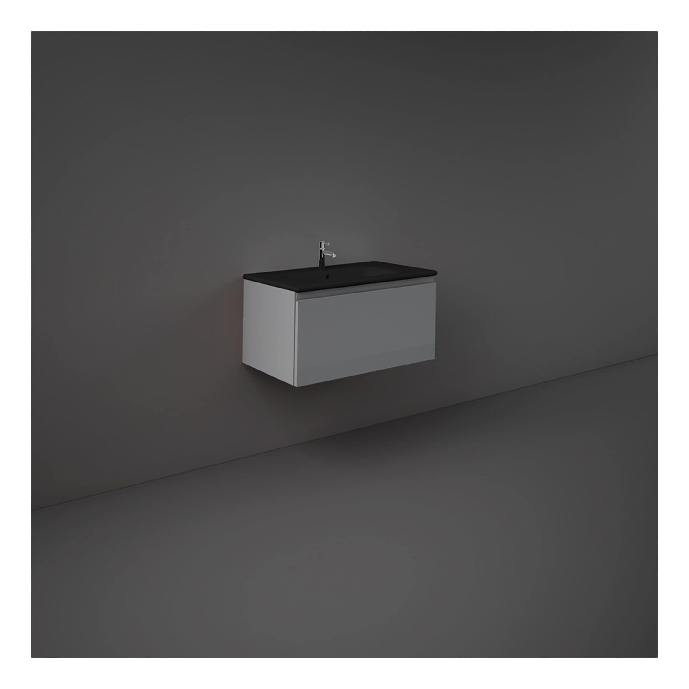 Minimalist bathroom vanity with black countertop and integrated sink against a dark grey wall, ideal for modern bathroom design.