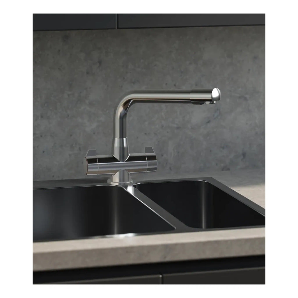 Sleek modern stainless steel kitchen tap installed over a double undermount sink with a grey stone countertop and wall backsplash.