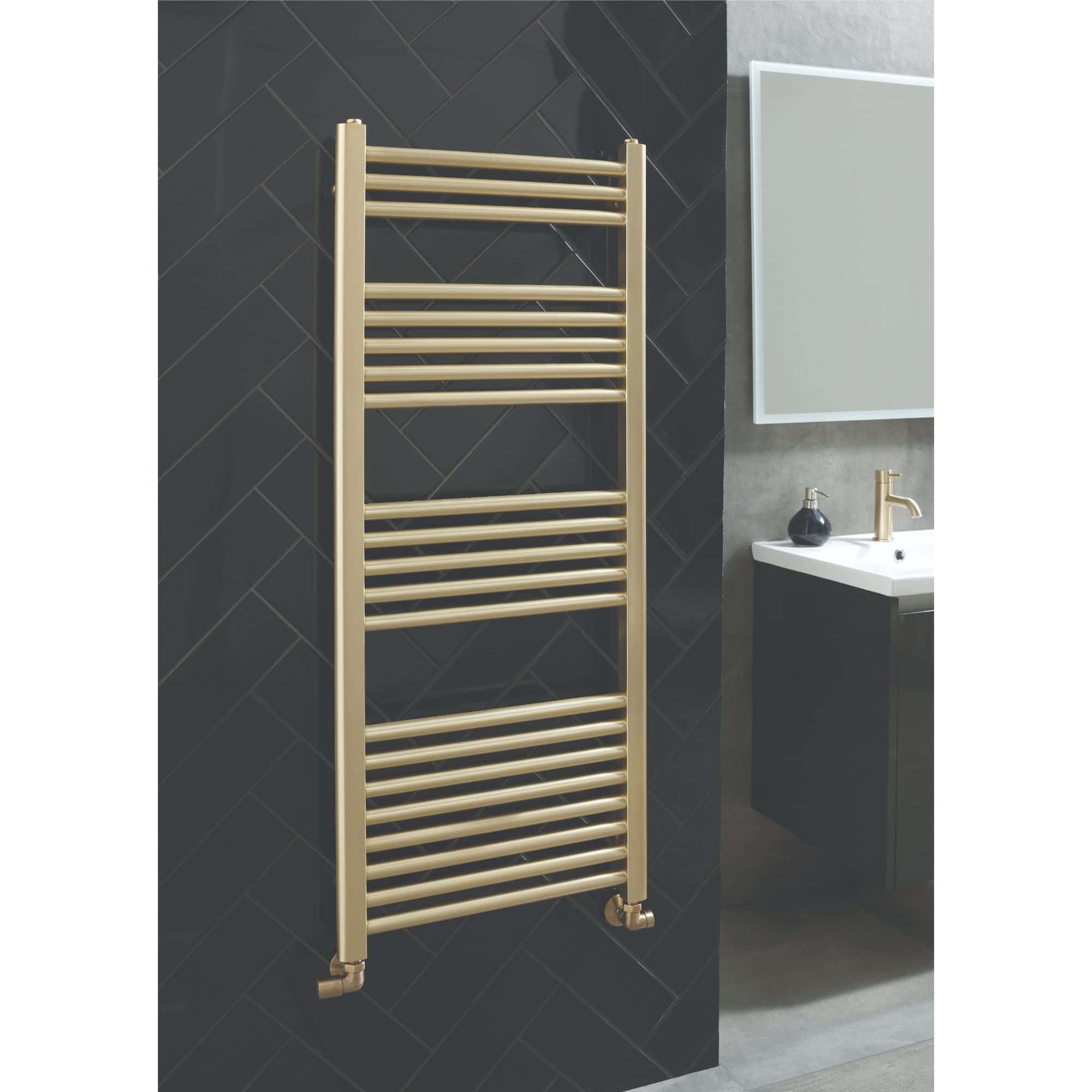 Sleek gold towel rail in modern bathroom with dark tiled wall and white sink, perfect for stylish bathroom heating and towel hanging solutions.