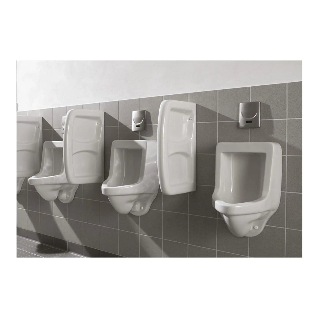 Urinals in a public bathroom, modern white ceramic sanitary fixtures with automatic sensor flush systems, set against grey tiled wall, for commercial or communal restroom facilities.