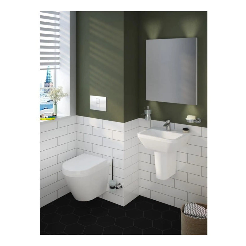 Sleek modern bathroom with wall-mounted toilet, compact sink, and stylish mirror, featuring green walls and white tiled wainscoting, ideal for contemporary bathroom renovation designs.
