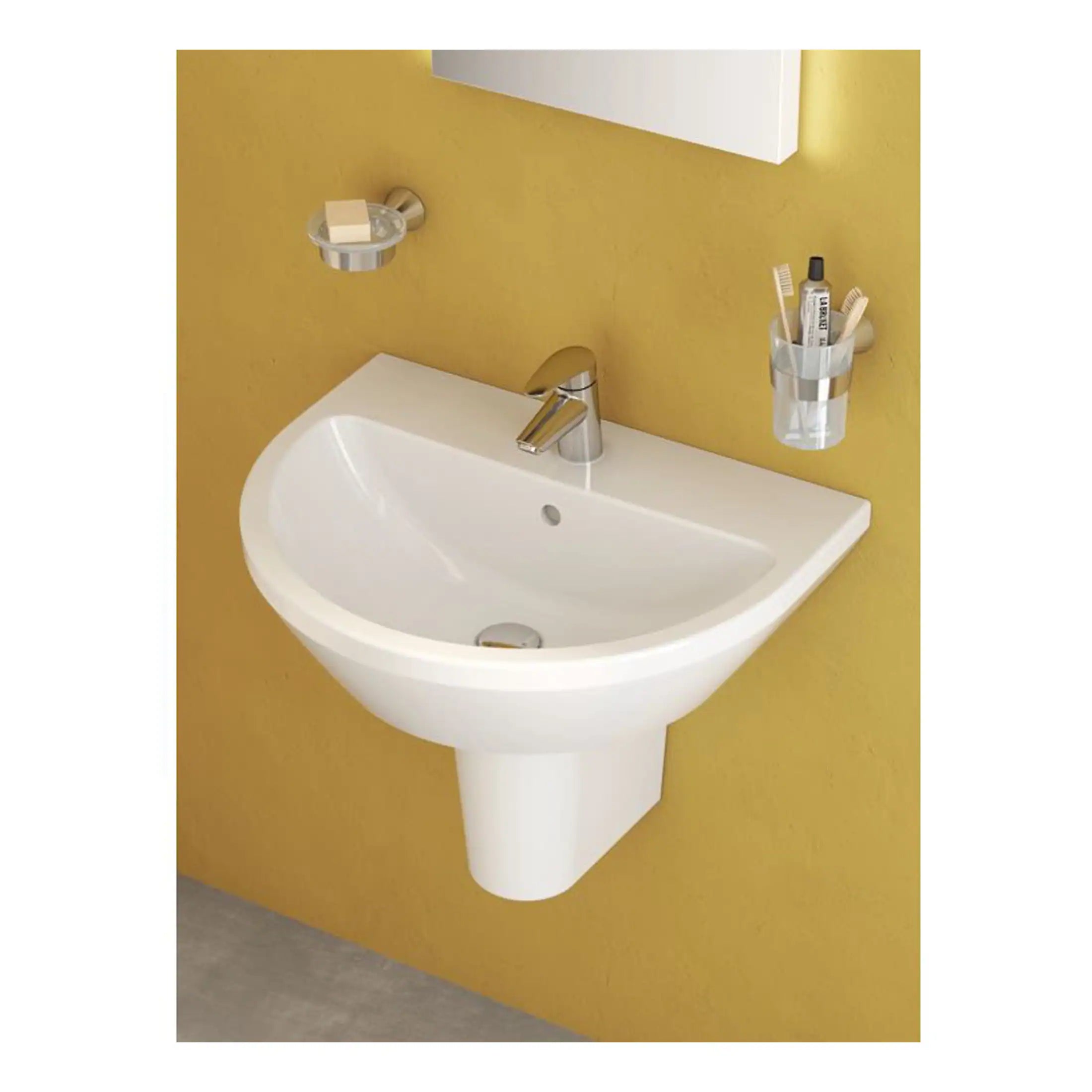 White ceramic bathroom sink with chrome faucet on yellow wall with soap dish and toothbrush holder, modern bathroom design, wall-mounted sink for contemporary bathroom decor, Bubly Bathrooms.