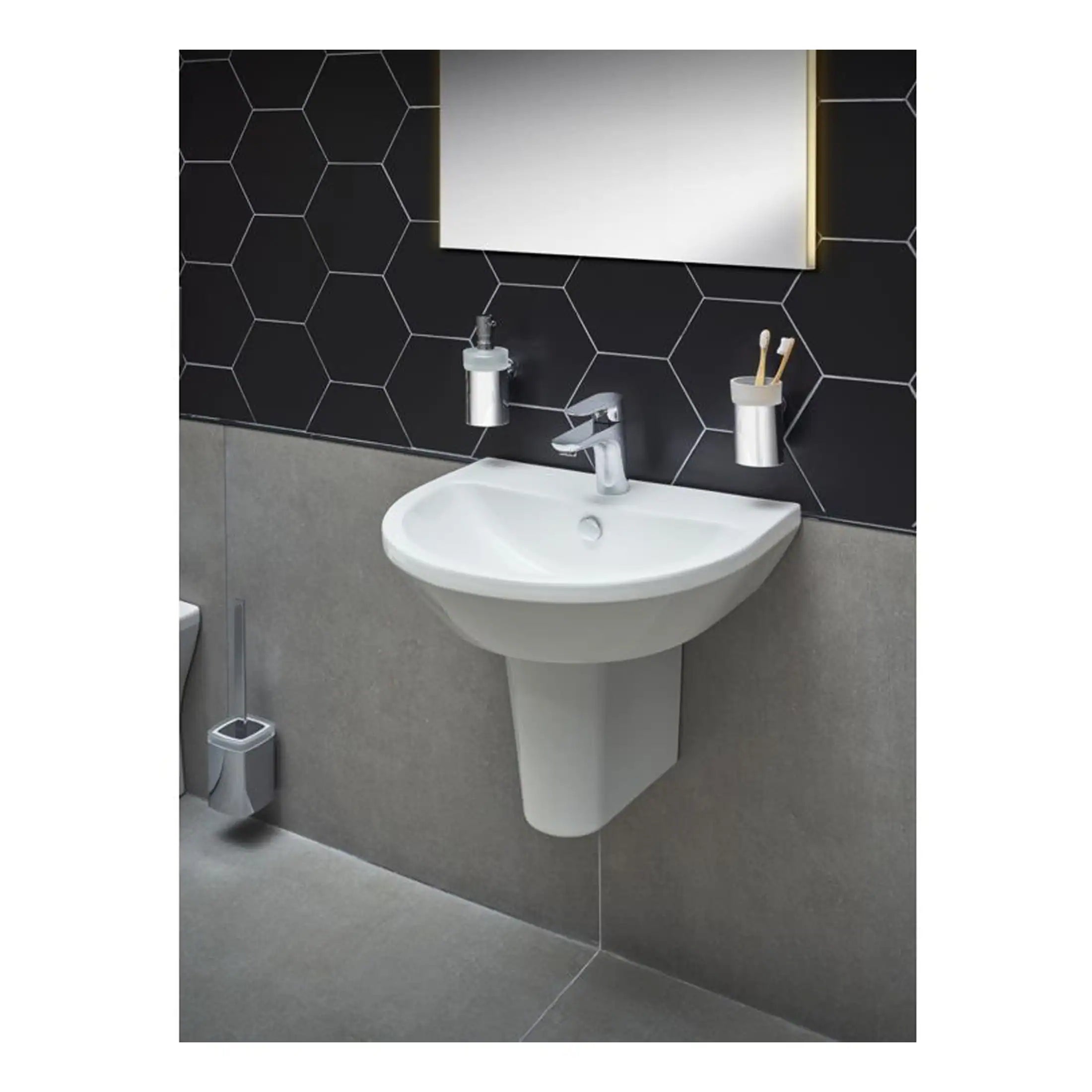 White ceramic bathroom sink with modern chrome tap, mounted on a grey wall with black hexagonal tile design, featuring bathroom accessories in a contemporary bathroom setting.