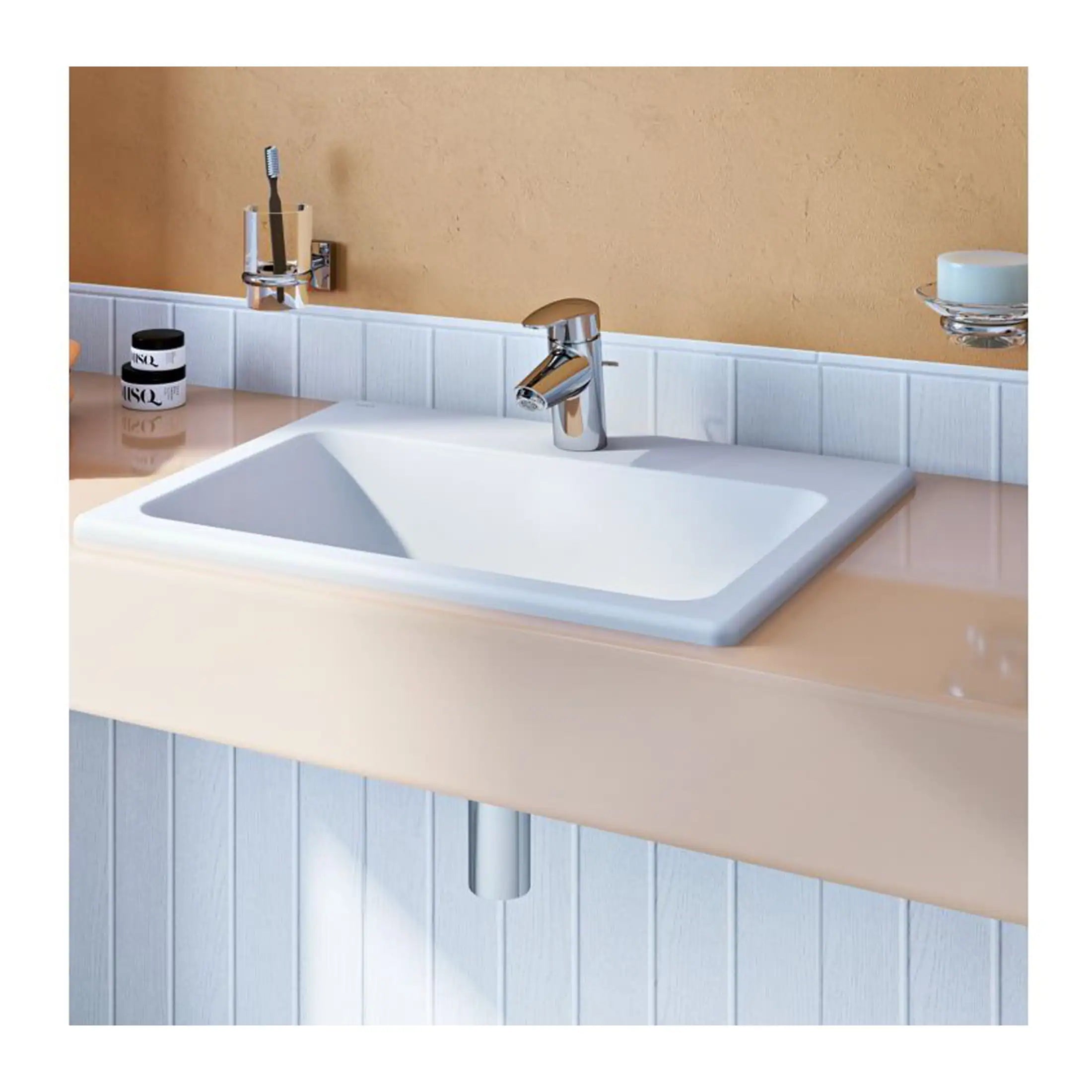 Sink with modern chrome faucet and beige countertop, bathroom decor with white tiles and beige wall, ideal for contemporary bathroom design.