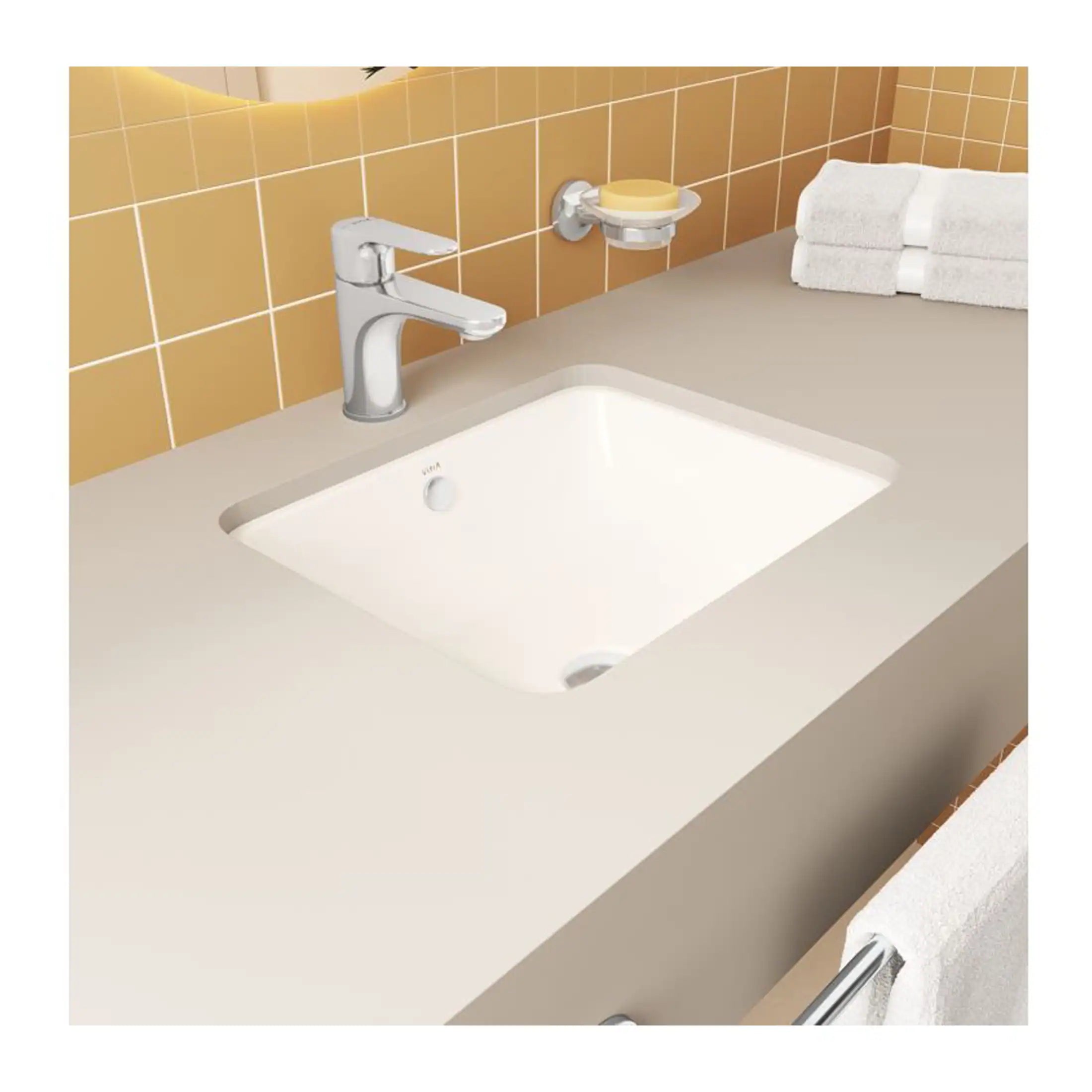 Bathroom sink with modern chrome tap, beige countertop, and neatly folded white towels, showcasing elegant and functional bathroom design.