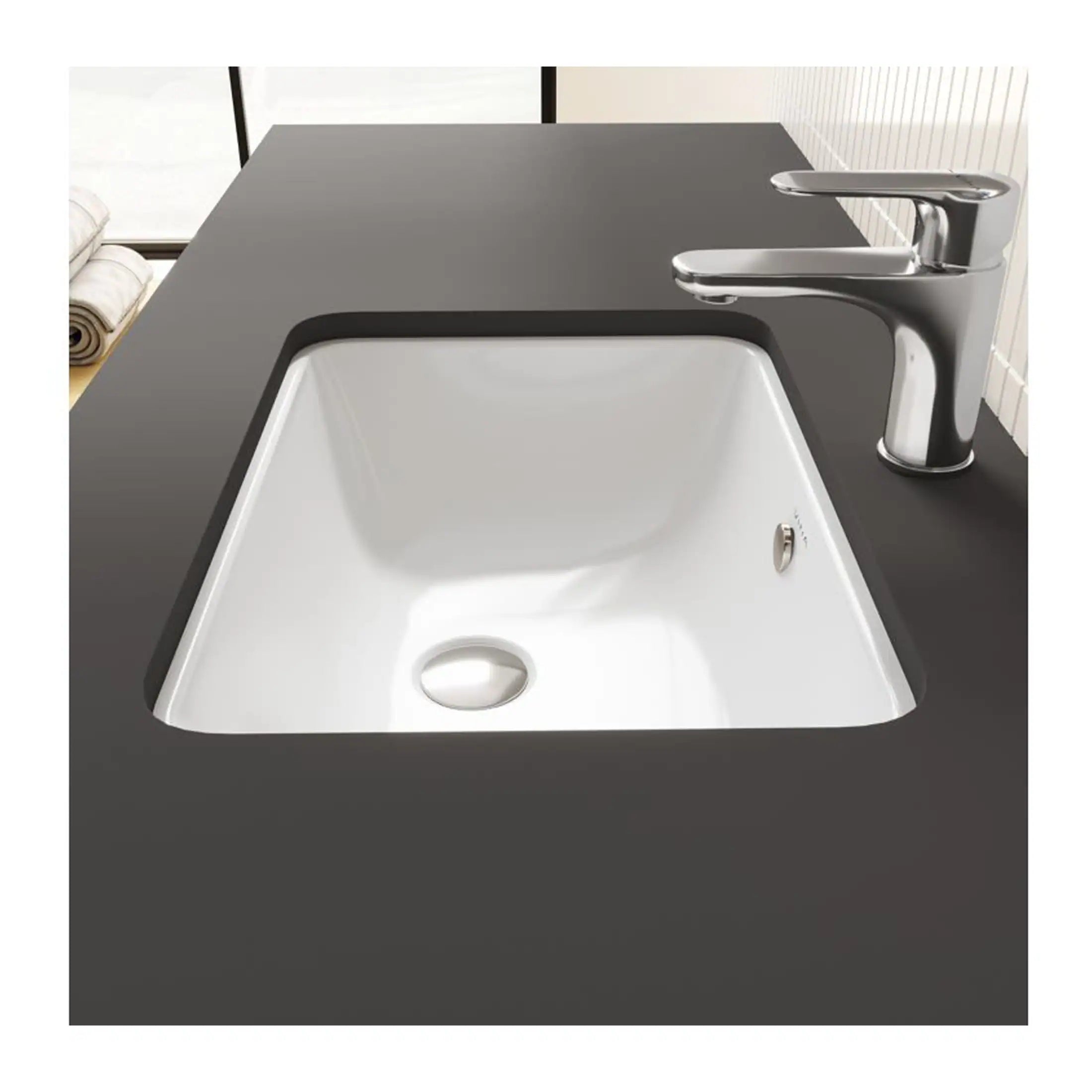 Modern kitchen sink with chrome faucet and black countertop, ideal for stylish and functional bathroom or kitchen renovations.