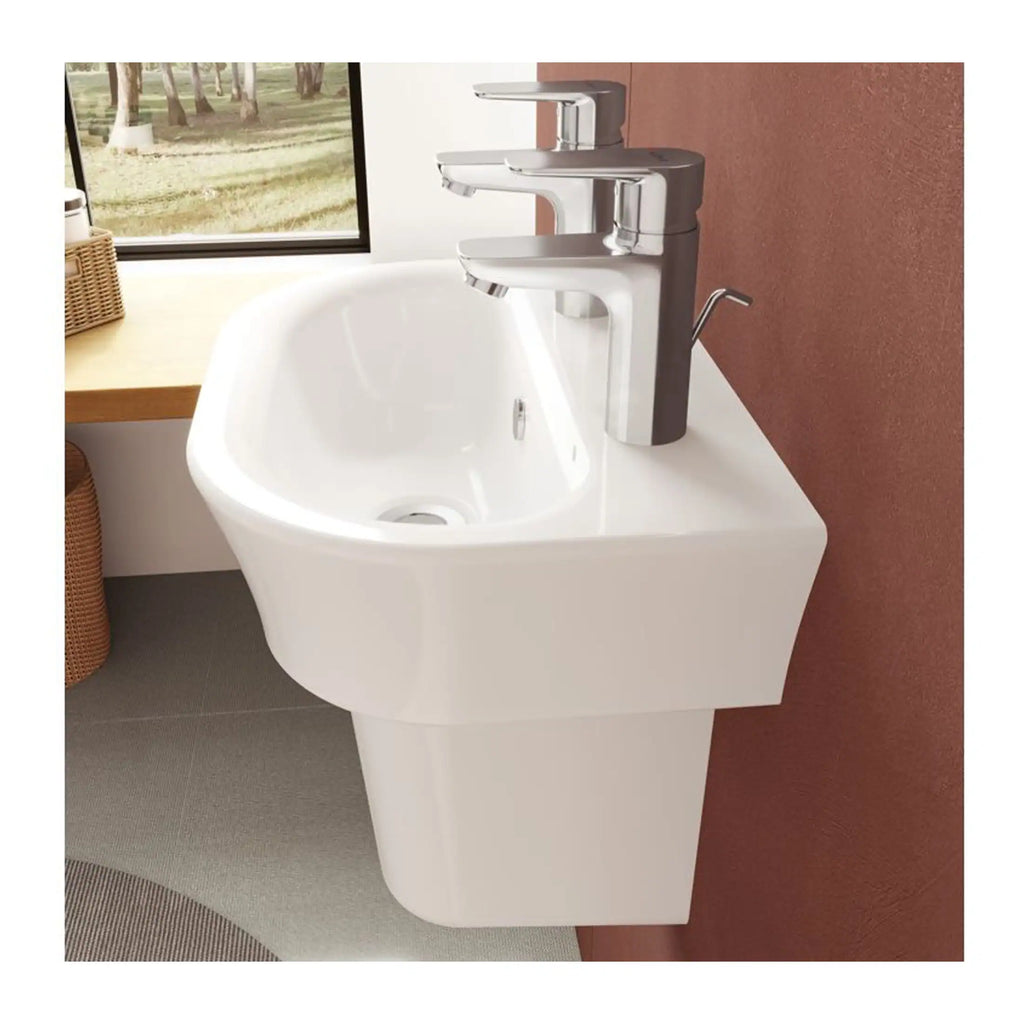 Contemporary white bathroom sink with modern chrome taps, installed against a textured accent wall in a stylish bathroom setting.