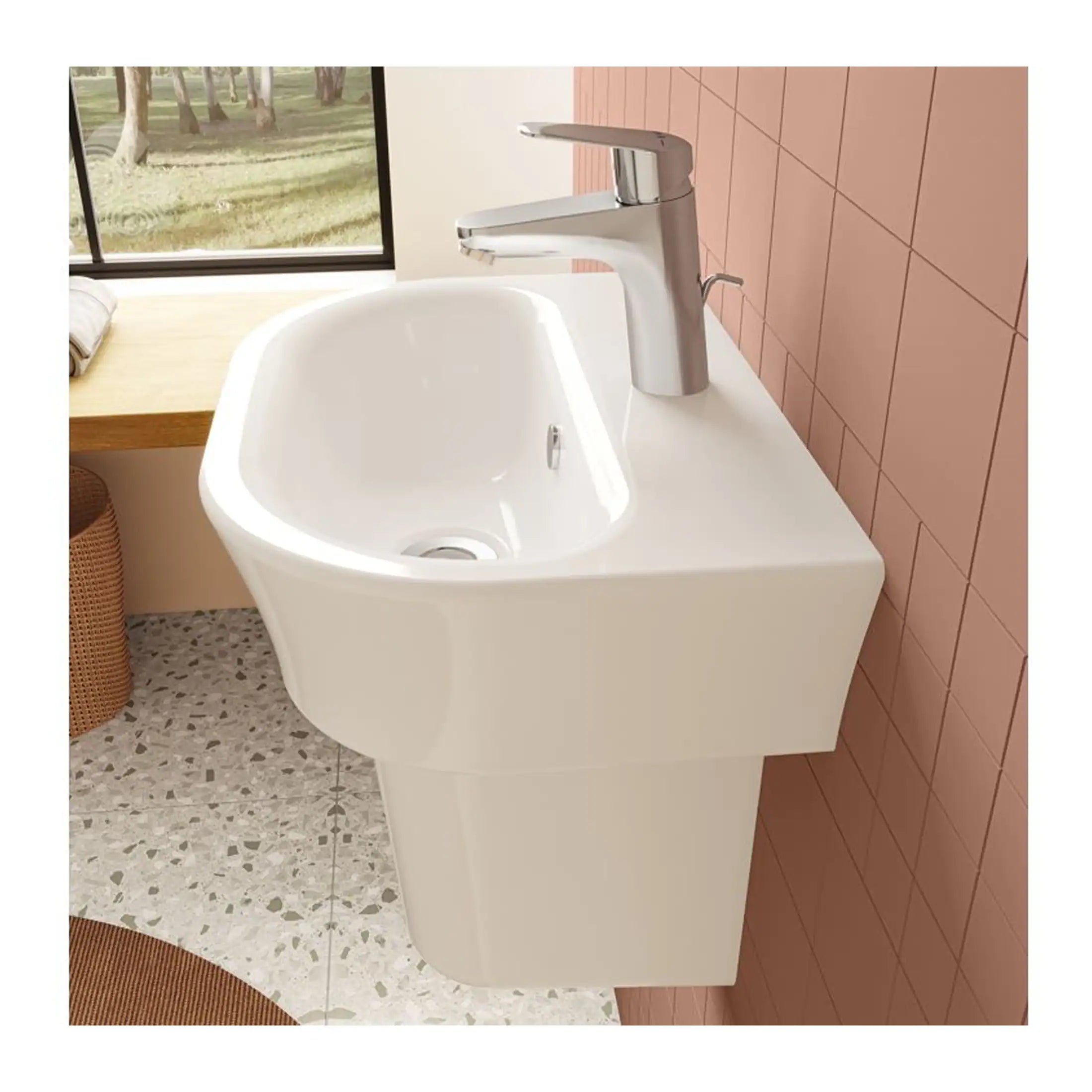 Contemporary white bathroom sink with modern chrome faucet installed against pink tiled wall and terrazzo flooring, ideal for stylish bathroom renovation projects.