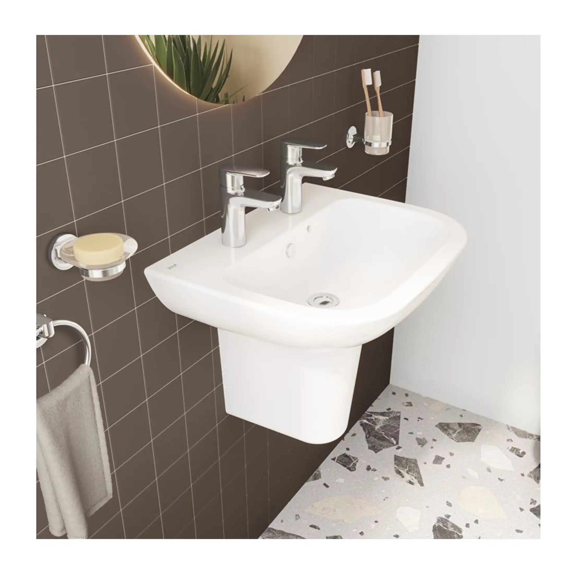 Smooth white bathroom sink with dual chrome faucets, mounted on a modern wall with dark tile background and contemporary decor accents.