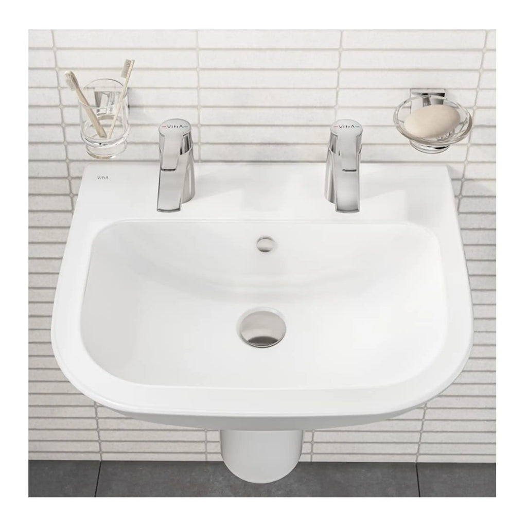 Clean white bathroom sink with dual chrome faucets, toothbrush holder, and soap dish, suitable for modern bathroom decor, part of Bubly Bathrooms collection.
