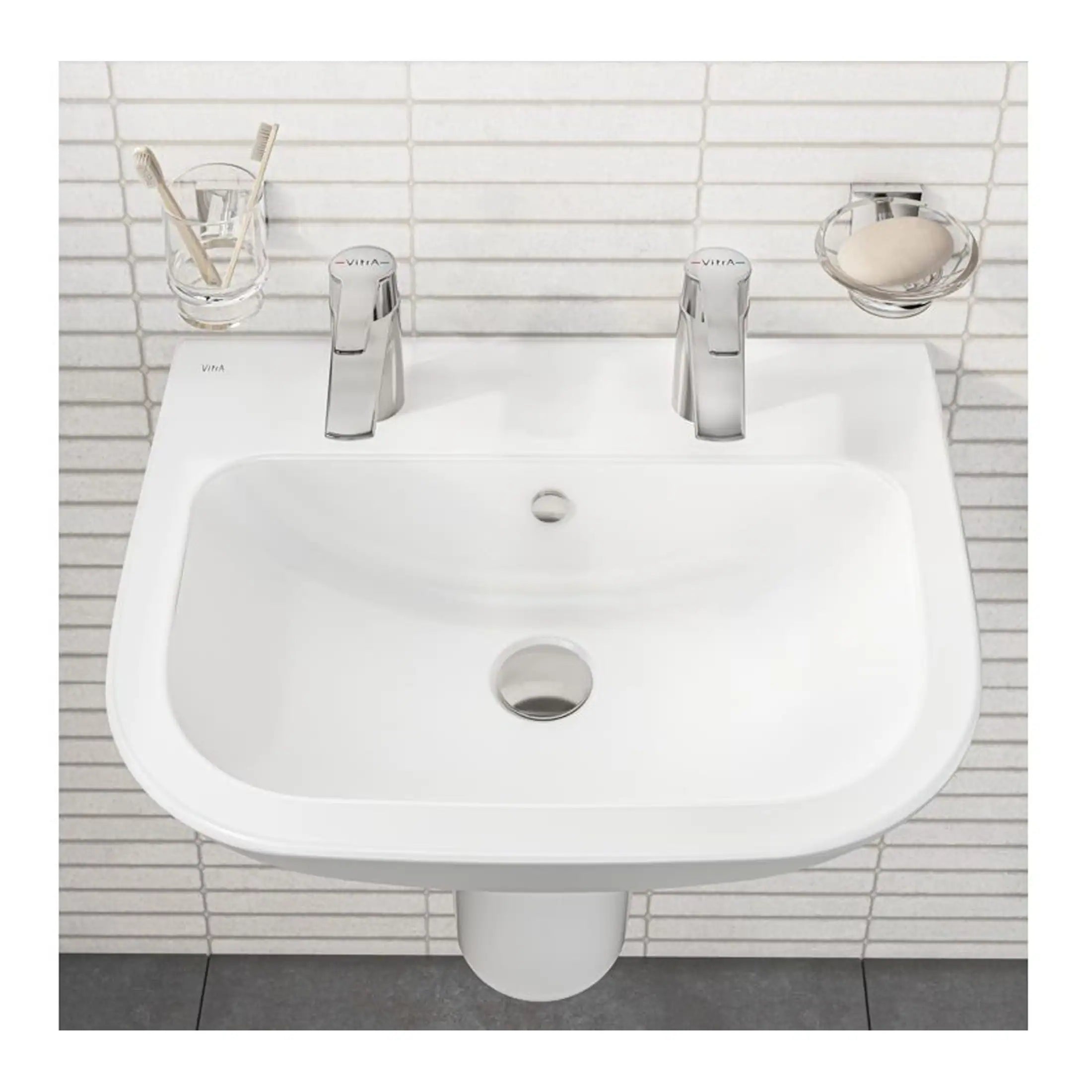 Clean white bathroom sink with dual chrome faucets, toothbrush holder, and soap dish, suitable for modern bathroom decor, part of Bubly Bathrooms collection.