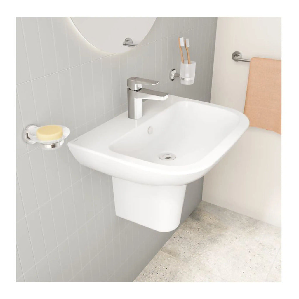 Sleek white bathroom sink with modern chrome tap, mounted on the wall with a mirror above, and accessories like toothbrush holder and towel rail, designed for contemporary bathroom decor.