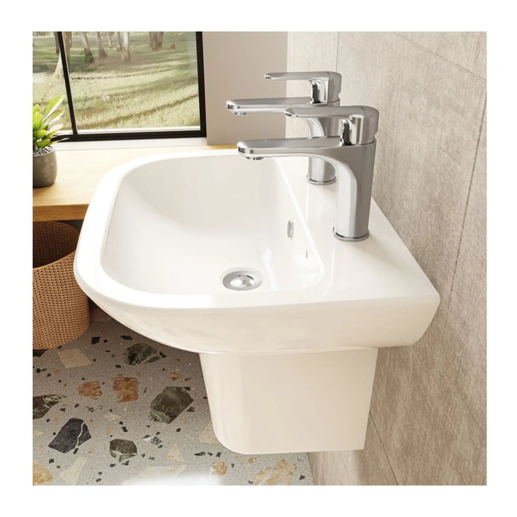 Modern wall-mounted white bathroom sink with chrome taps, set against a neutral tiled wall with a window overlooking greenery, ideal for contemporary bathroom decor.
