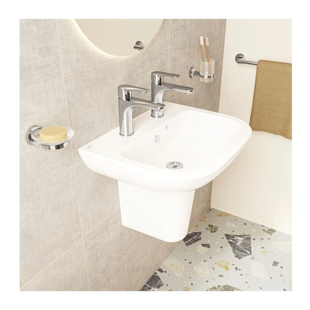 Sleek white bathroom sink with modern chrome taps, wall-mounted for space-saving, featuring accessories like soap dish, toothbrush holder, and towel rail, perfect for contemporary bathrooms.