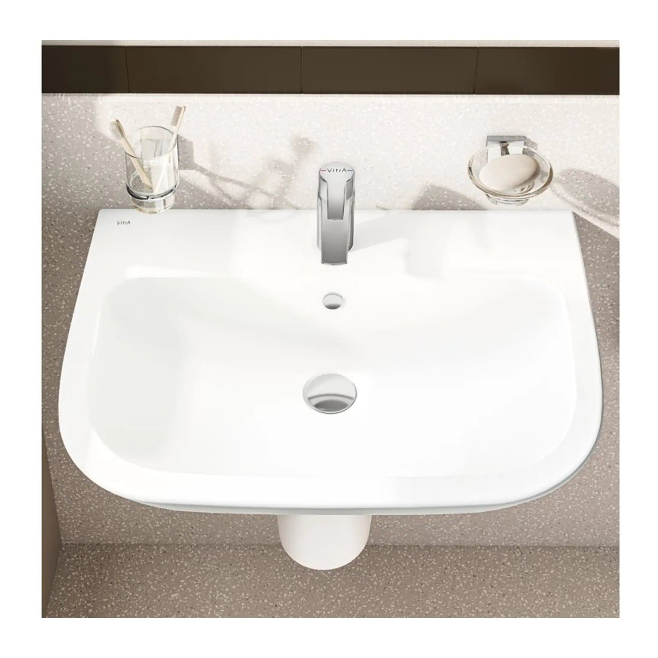 Clean white bathroom sink with modern chrome faucet, soap dish, and toothbrush holder, showcasing elegant bathroom fixtures by Bubly Bathrooms. Perfect for stylish and functional bathroom design.