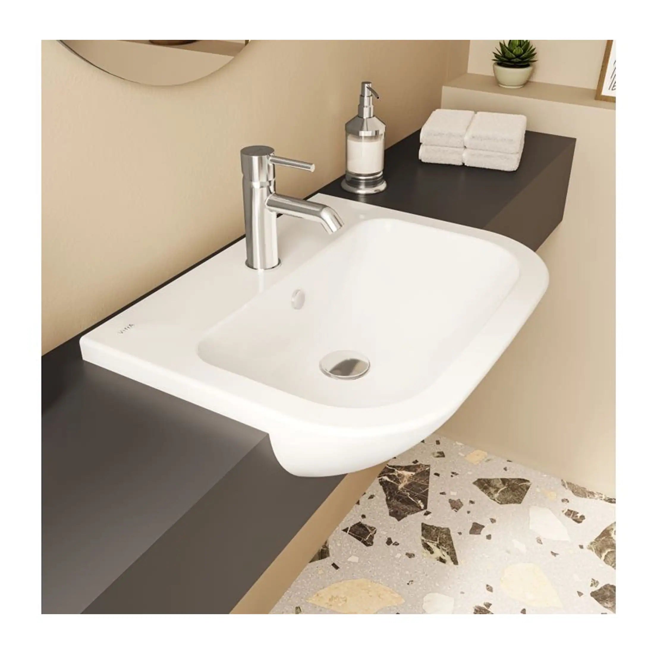 Sleek white bathroom sink with modern chrome faucet, set on a black countertop with soap dispenser, folded towels, and a small potted plant, designed for contemporary bathroom aesthetics.
