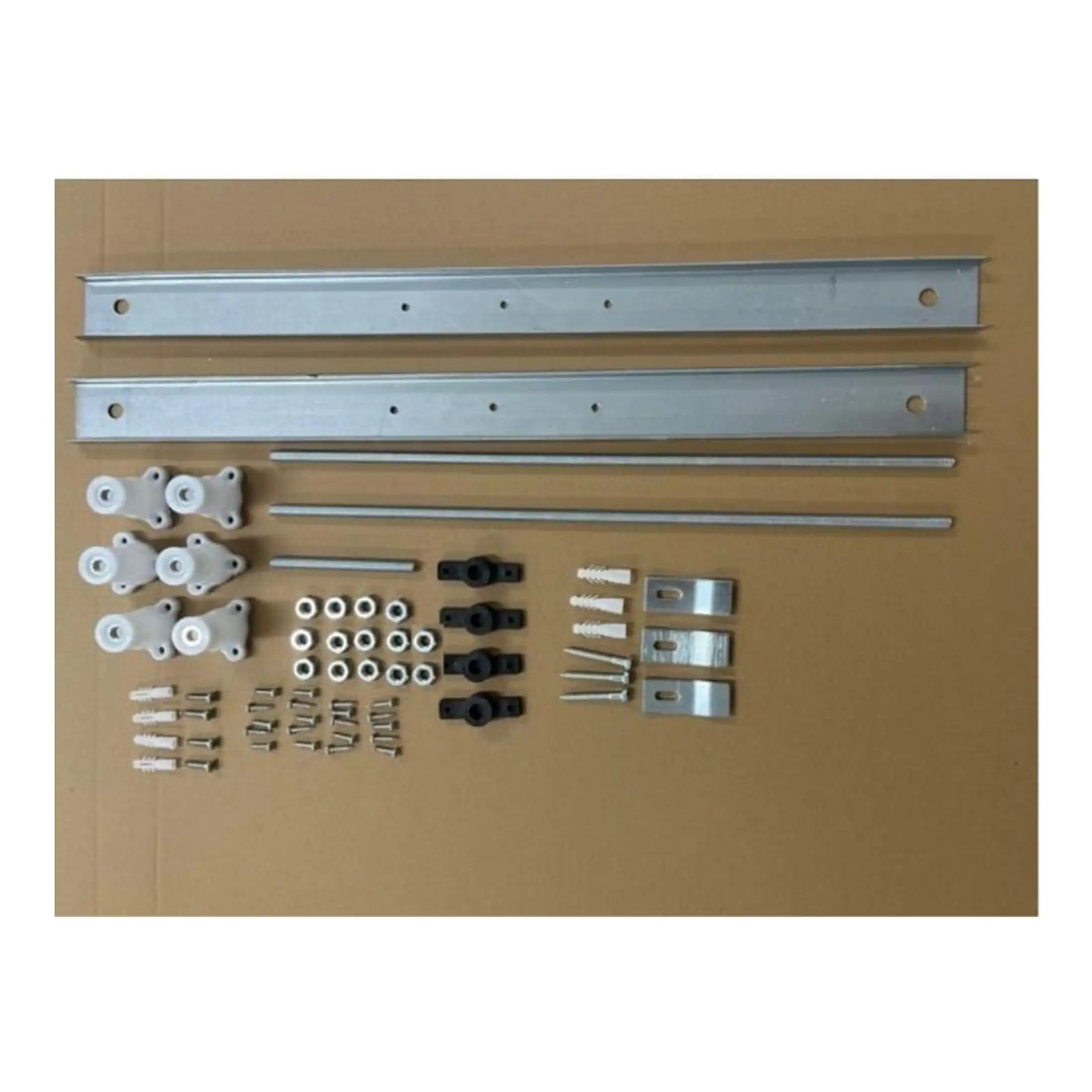 Disassembled bathroom installation kit with rails, brackets, screws, and rollers for bathtub or shower enclosure fitting. Essential accessories for bathroom decor and fixture setup.