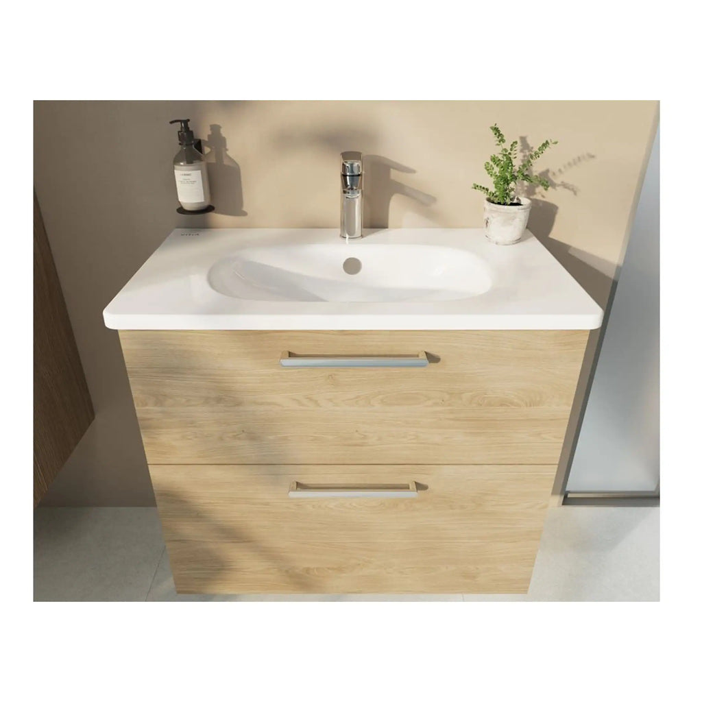Minimalist bathroom vanity with a white countertop, integrated sink, and wooden storage drawers, featuring a chrome handle and a potted plant for a natural touch. Ideal for modern bathroom designs.