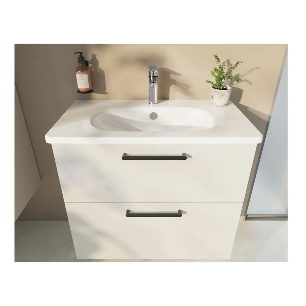 Sleek modern white bathroom vanity with integrated sink, chrome handles, and a beige wall backdrop, complemented by a soap dispenser and a potted green plant for a fresh bathroom design.