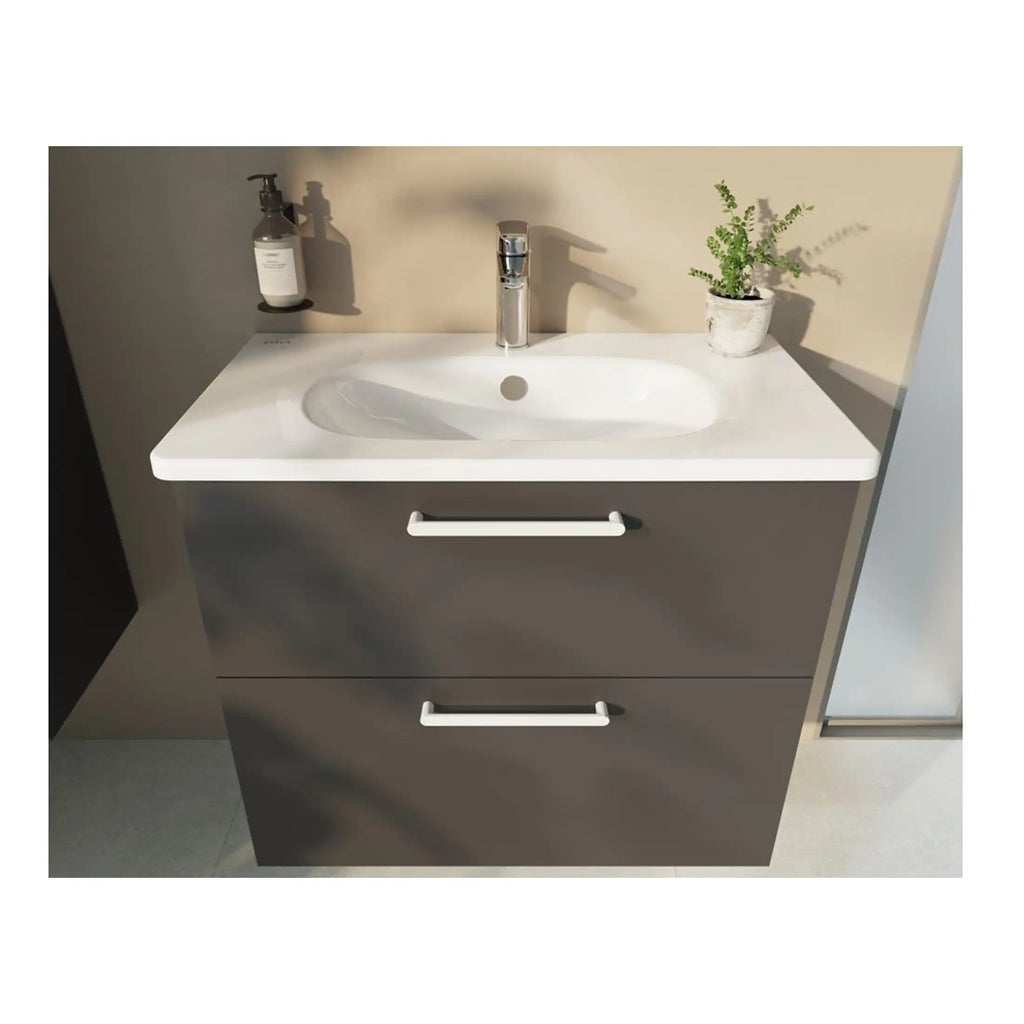 Modern bathroom vanity unit with integrated sink, chrome handles, and a sleek, minimalist design perfect for contemporary bathroom interiors. Includes a faucet, soap dispenser, and decorative plant.