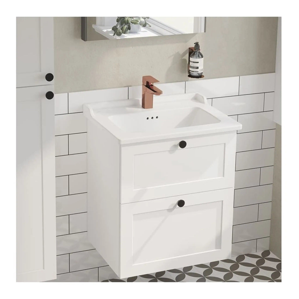 Sleek white bathroom vanity cabinet with integrated sink and copper faucet in a modern bathroom setting, featuring stylish black knobs and a patterned floor for contemporary bathroom decor.