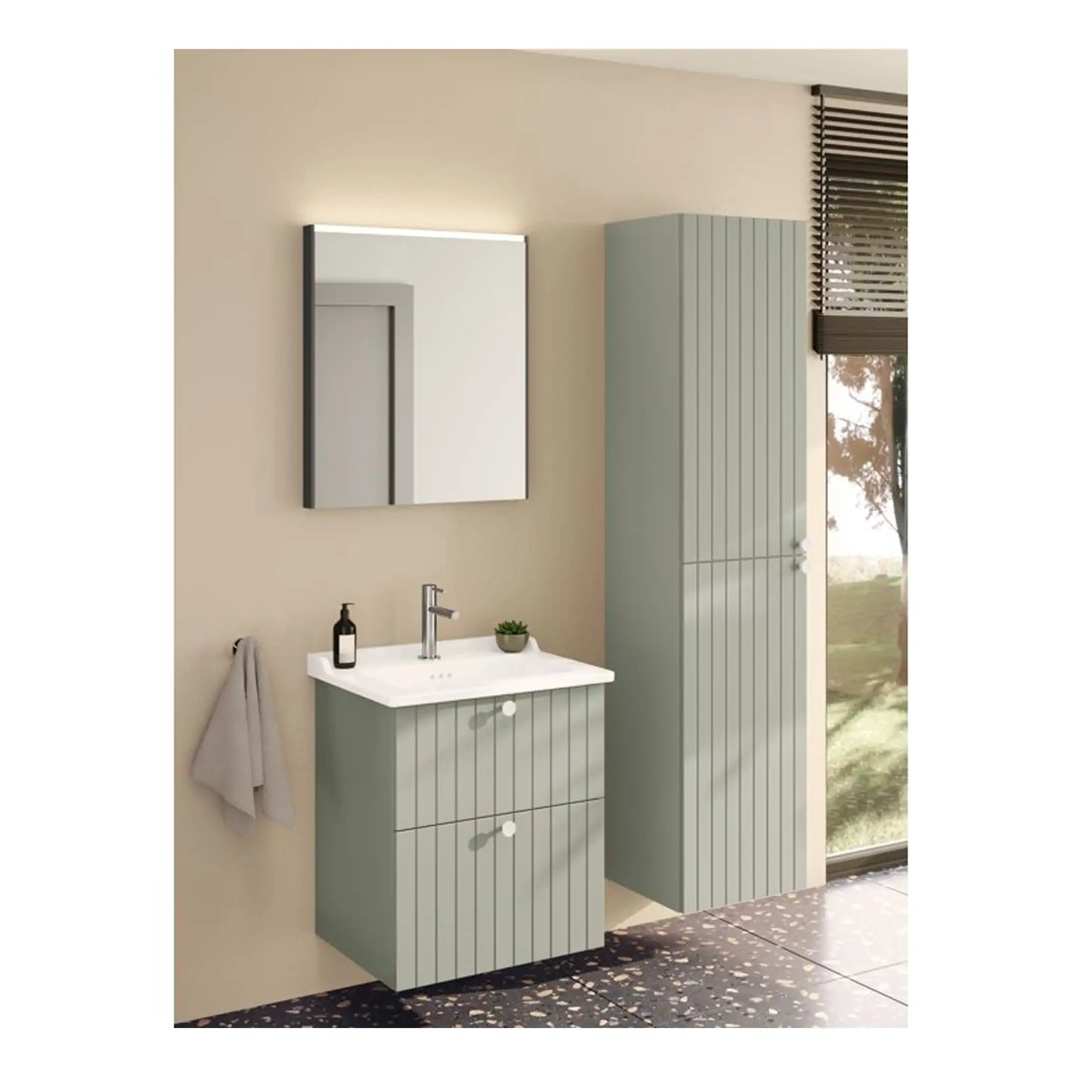 Sleek green bathroom vanity with matching tall storage cabinet, modern wall mirror with LED lighting, and minimalist accessories in a bright, contemporary bathroom setting.