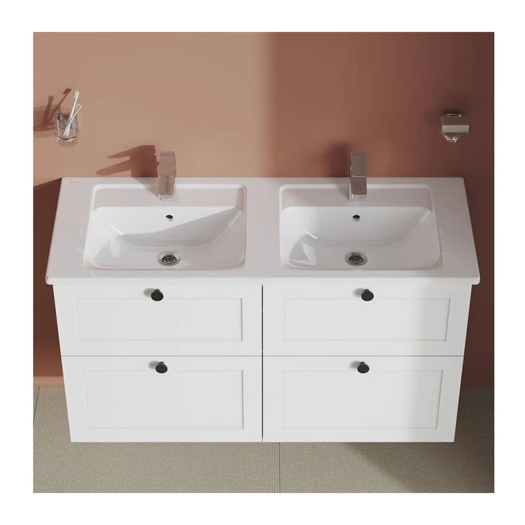 Double modern white bathroom vanity with two sinks and chrome fixtures, set against a warm-toned wall, showcasing stylish bathroom design and plumbing features.