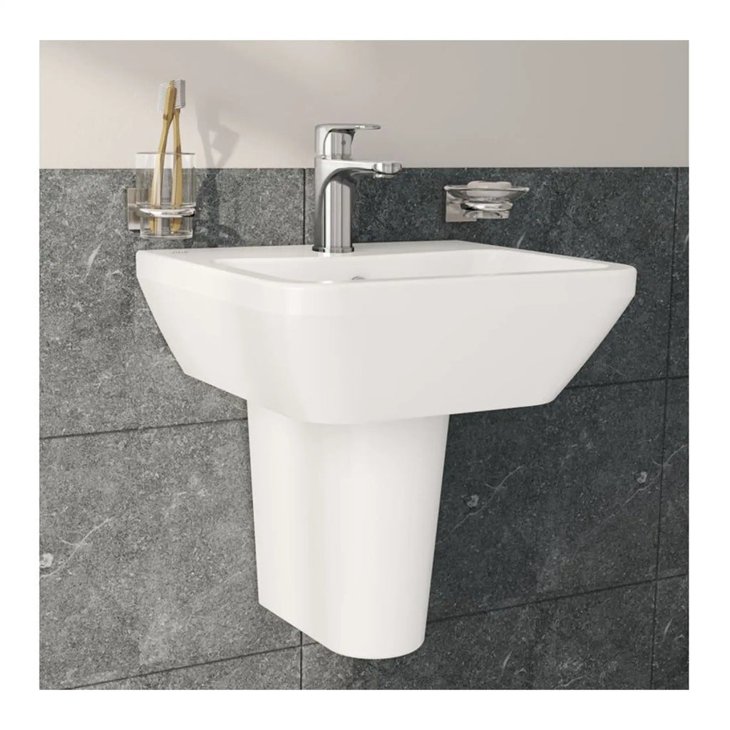 Modern white bathroom sink with chrome faucet mounted on a grey tiled wall, perfect for contemporary bathroom designs.