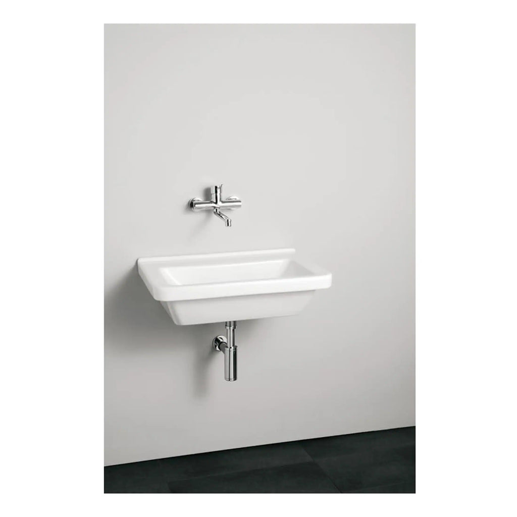 Modern white wall-mounted bathroom sink with chrome mixer tap and black tiled flooring, showcasing contemporary bathroom fixtures and minimalist design.