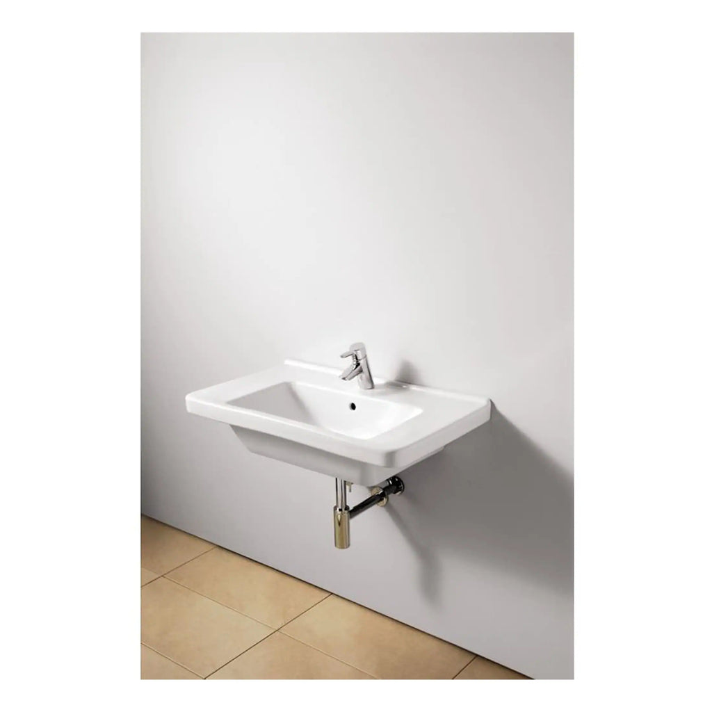 Wall-mounted white bathroom sink with chrome tap and exposed plumbing, ideal for modern bathroom or powder room interiors. Compact design perfect for limited space bathrooms.