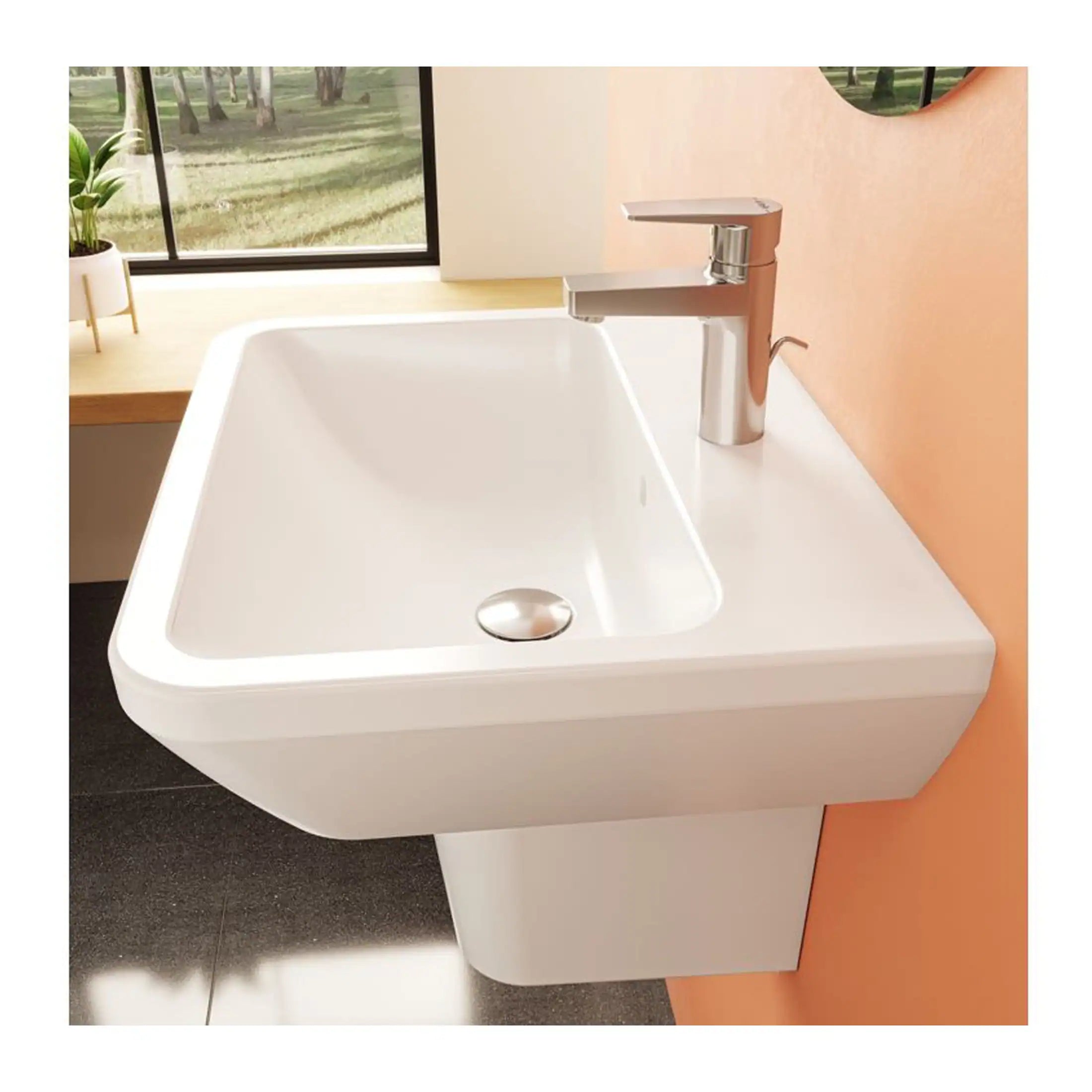 Modern white bathroom sink with sleek chrome faucet, mounted on a wall, with a large window and potted plant nearby for a fresh, stylish bathroom design.