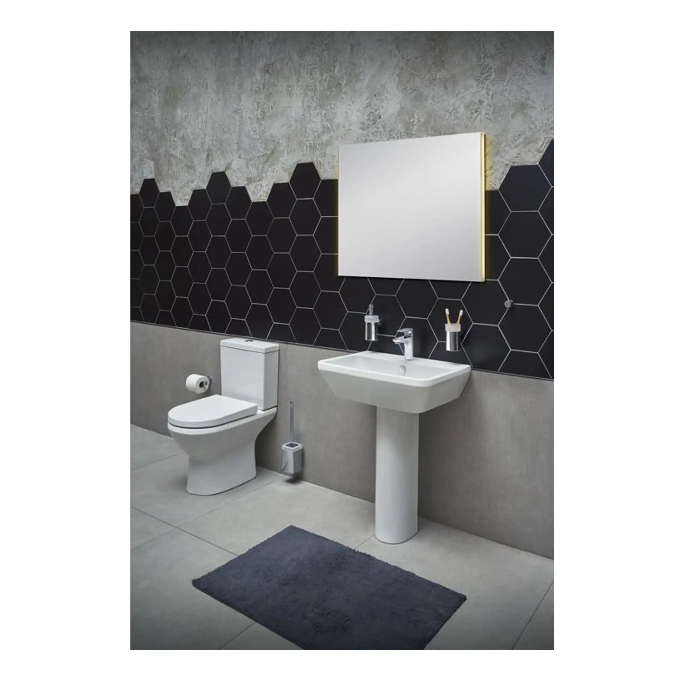 Sleek modern bathroom with black hexagonal tiled wall, white ceramic toilet and pedestal sink, illuminated mirror, and minimalist accessories, showcasing contemporary bathroom design.