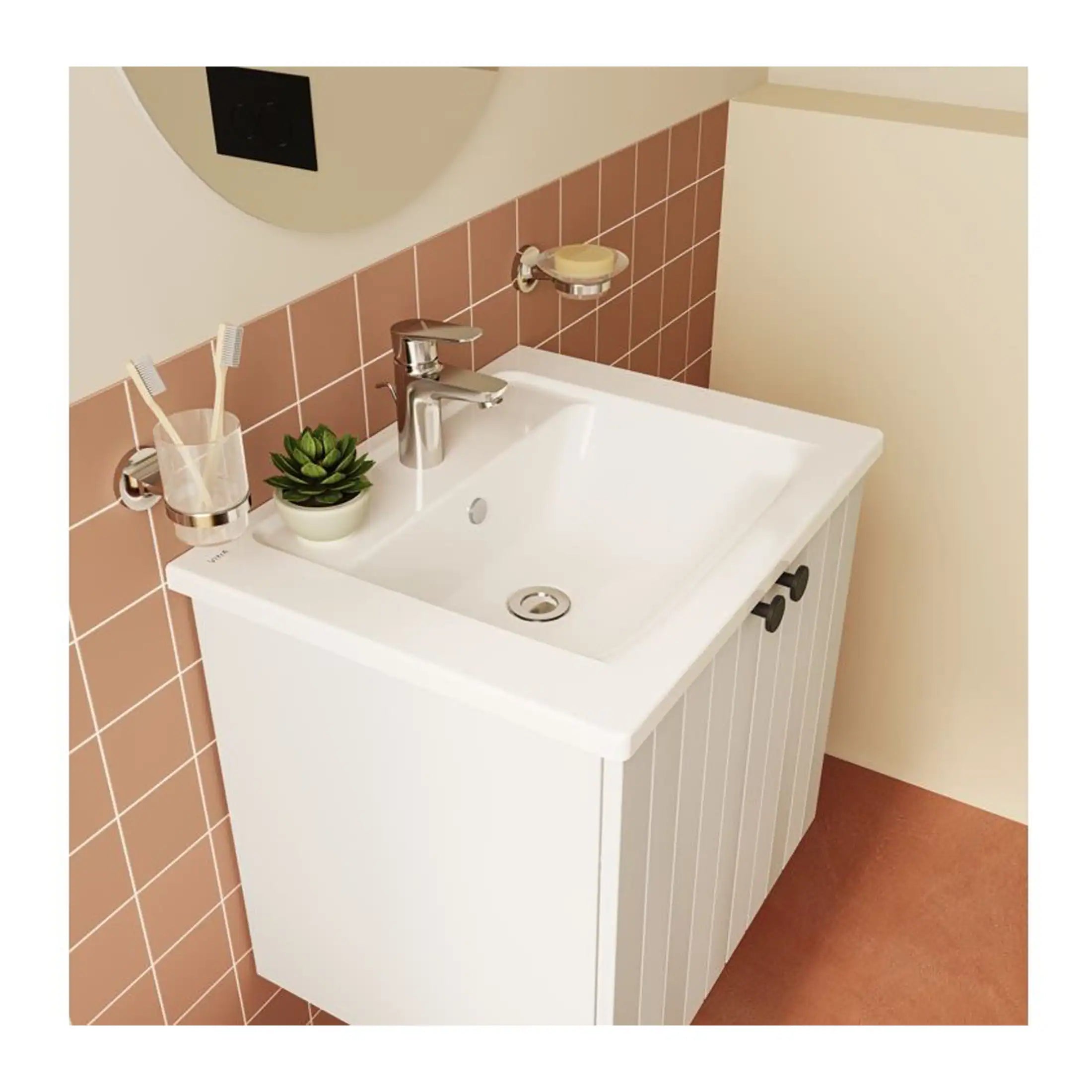 Bright white bathroom vanity with integrated sink, chrome faucet, and wall-mounted bathroom accessories, including toothbrush holder, soap dish, and small potted plant for bathroom decor.