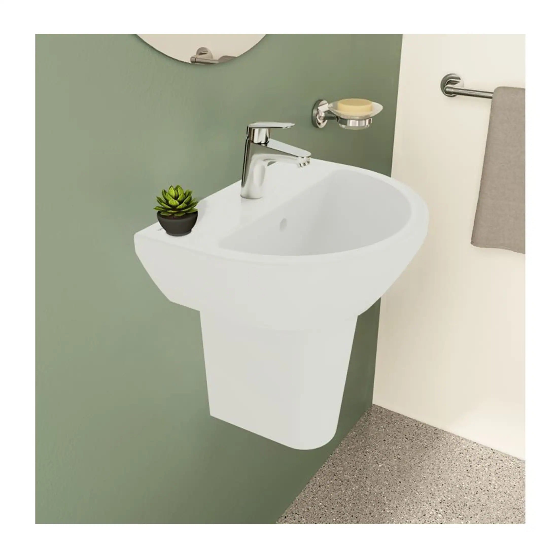 White modern bathroom sink with chrome faucet, small potted succulent plant, soap dish, and towel rail in a contemporary bathroom setting.