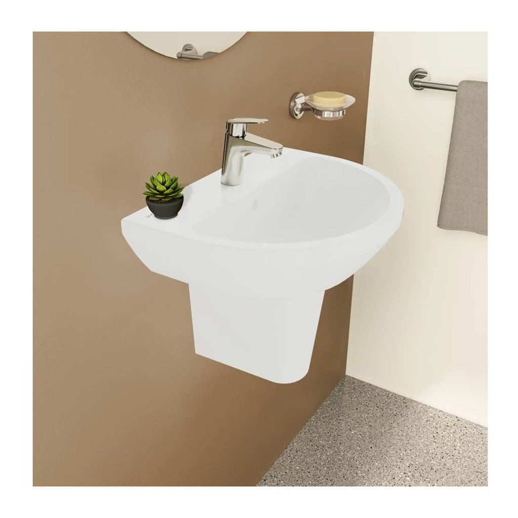 Clean white wall-mounted bathroom sink with modern chrome faucet, small potted plant, wall soap dish, and towel holder, stylish and functional bathroom design.