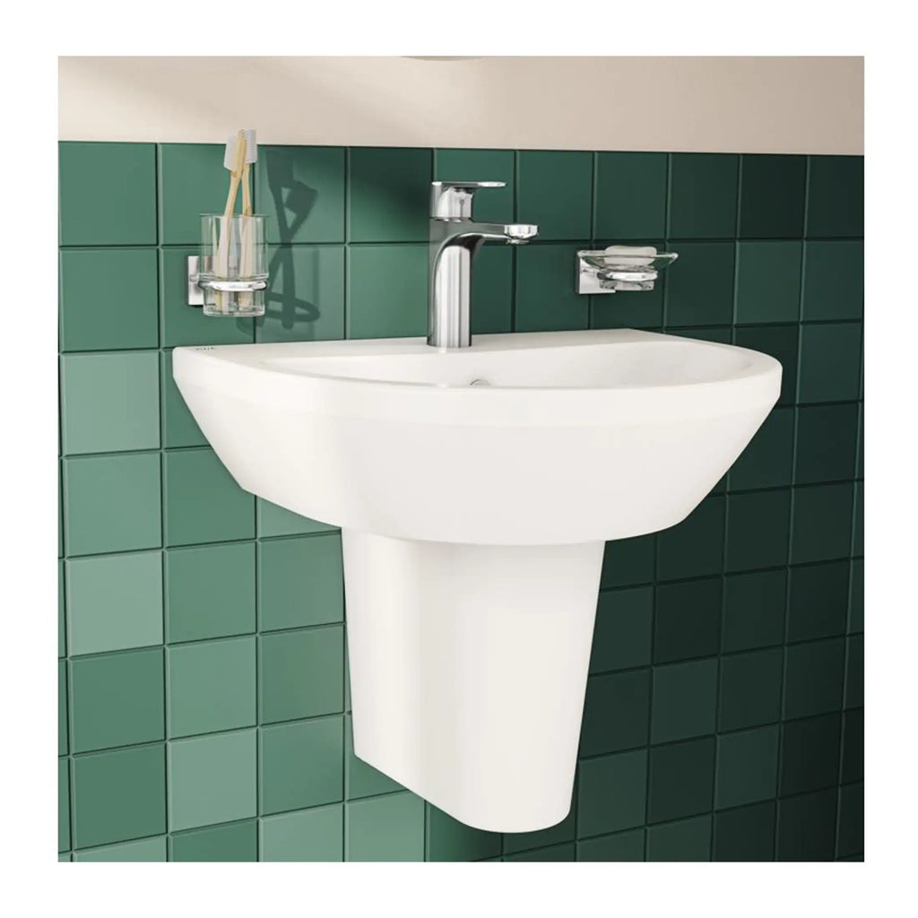 Square white bathroom wash basin with chrome tap mounted on green tiled wall, modern bathroom fixture, stylish sink for contemporary bathroom designs, high-quality sanitaryware.