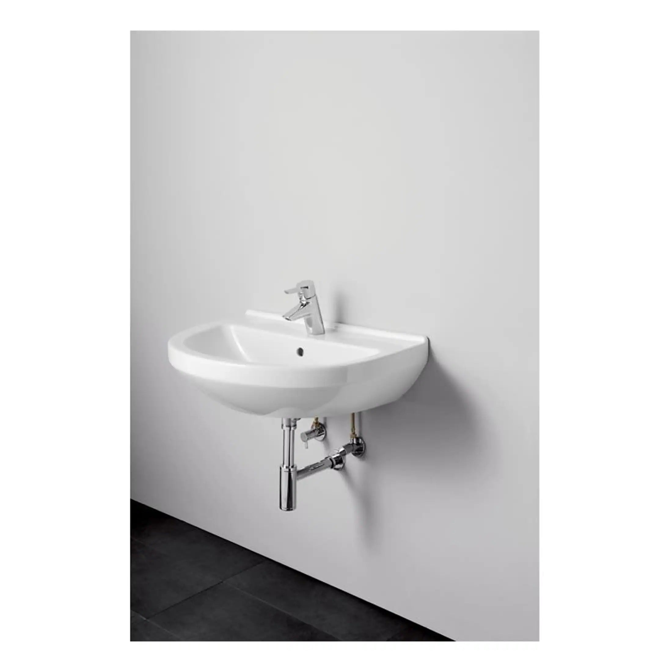 Compact white bathroom sink with modern chrome faucet, wall-mounted design, minimalistic style, ideal for contemporary bathrooms, with visible plumbing, on a plain white background.