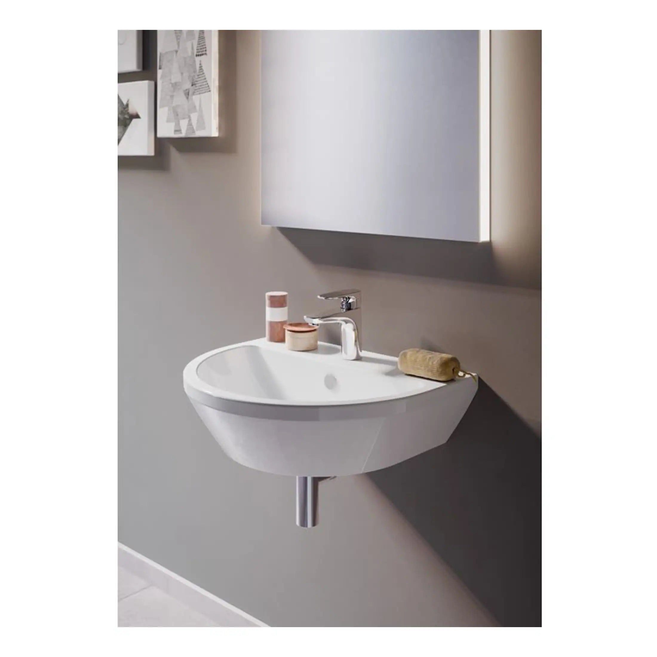 Contemporary wall-mounted bathroom sink with a clean design, chrome tap, and minimalist accessories, set in a modern bathroom with neutral colour tones for stylish functionality.