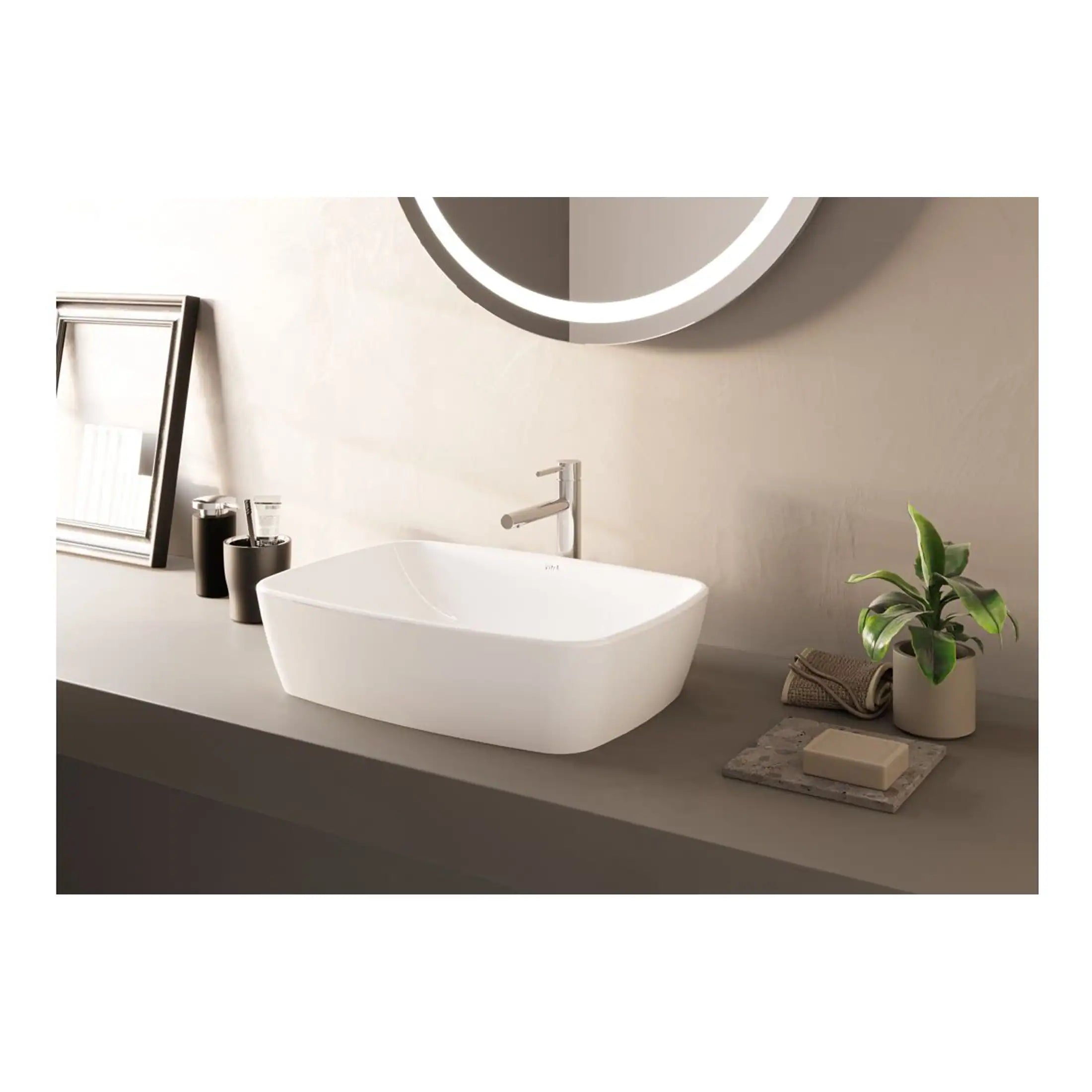 Sleek modern white bathroom sink with minimalist design, paired with contemporary fixtures, a mirror with integrated lighting, and stylish accessories for a clean and elegant bathroom decor.